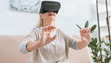 A woman using an AppliedVR headset at home