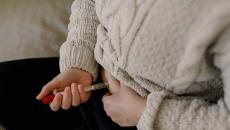 A close up of a person injecting fertility medication into their abdomen