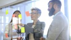 People looking at a board with post-it notes