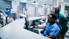 Providers using a computer in a hospital. 