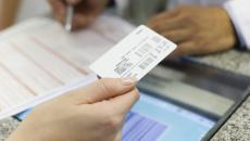 Insurance card being passed across a counter