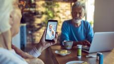 A couple talking on a smartphone telehealth visit