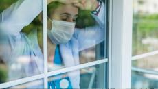 Tired doctor looking out of window