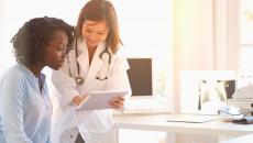 Healthcare provider showing someone a tablet