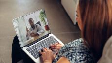 Person on a computer speaking with a healthcare provider