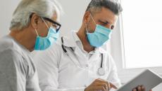 Healthcare provider and patient looking at a tablet