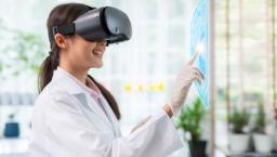 Healthcare provider wearing a virtual reality headset while touching a virtual screen