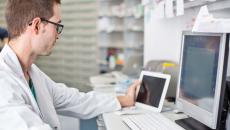 Healthcare provider looking at two computers